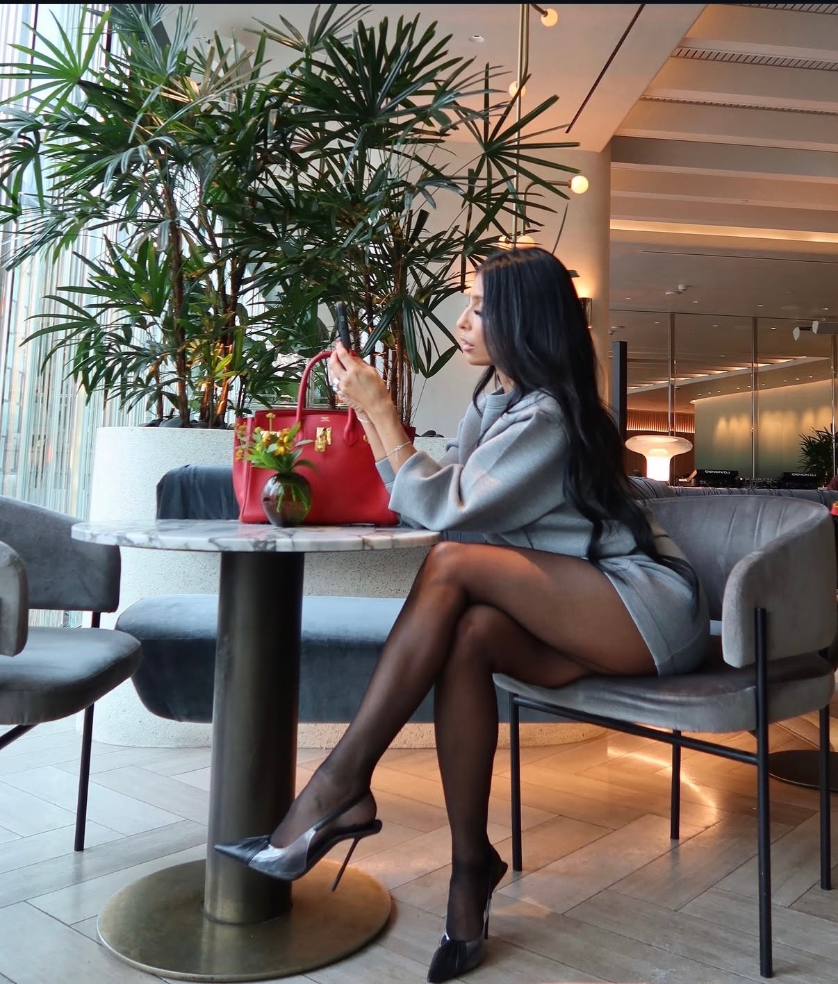 Hotel lobby, gray blazer dress with red Birkin